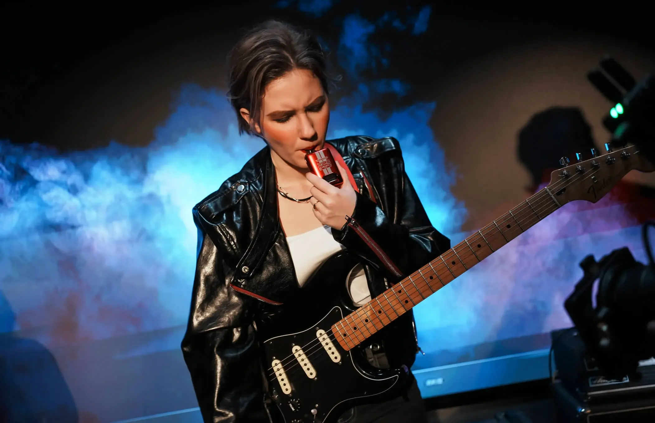 A man exhaling vapor from a VAPORESSO VIBE device, highlighting the "DUAL MESH" technology for enhanced flavor and vapor production.